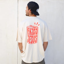 Load image into Gallery viewer, Enjoy Jesus t-shirt worn by man. Oversized fit in cream color.
