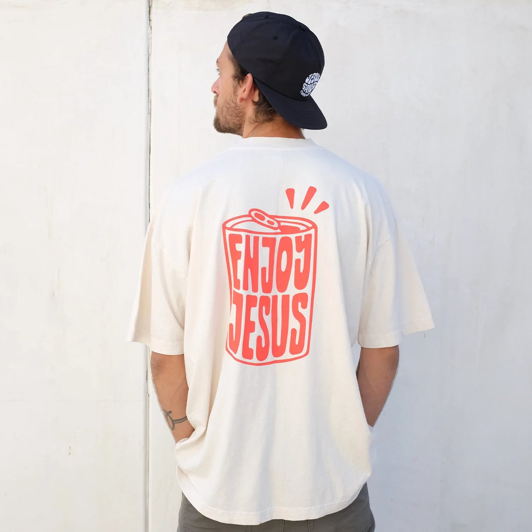 Enjoy Jesus t-shirt worn by man. Oversized fit in cream color.